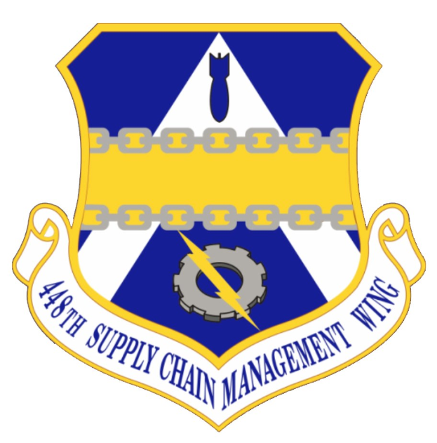Logo des 48. Versorgungsgeschwader mit einem blauen Schild mit einem weißen Stern und einem weißen Banner mit der Aufschrift "Versorgungsgeschwader" in blau, alles von einem weißen Rand umgeben und mit dem Text "48. Versorgungsgeschwader" in fetter schwarzer Schrift.